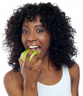African American Woman eating apple